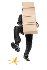 Person with paper boxes about to step on a banana peel