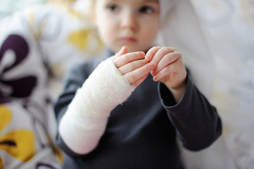 Little girl showing her bandaged hand