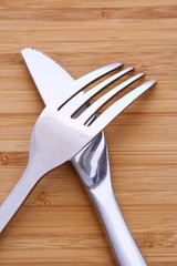Solid fork and knife on wood table