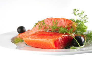 pink salmon on white plate with olives