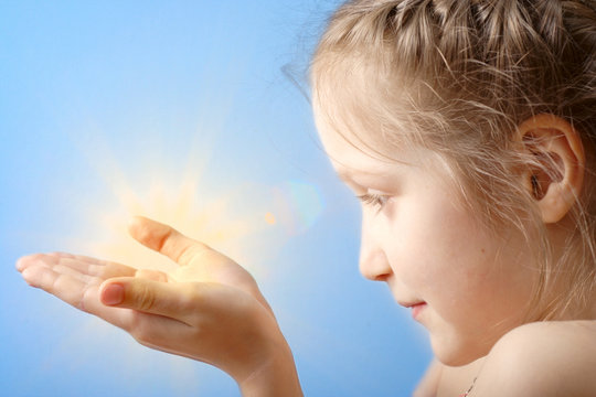 child holding a sun