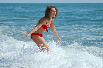 Fototapeta premium Happy woman stand at coast with the lifted hands