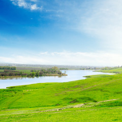 lake and green field