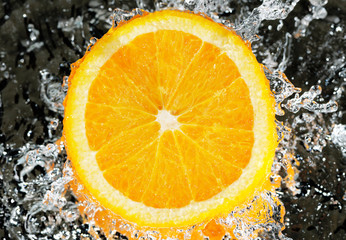 Fototapeta na wymiar fresh orange in streaming water