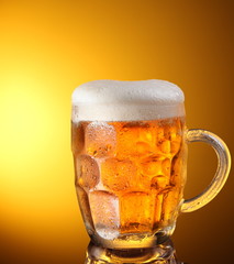 glass of beer on a yellow background