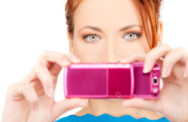redhead woman using phone camera