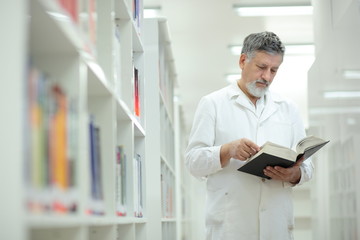 Fototapeta premium Renowned scientist/doctor in a library of research center/hospit