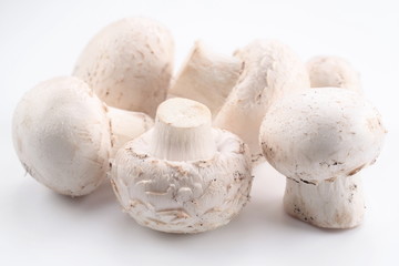 Handful of champignons on a white background