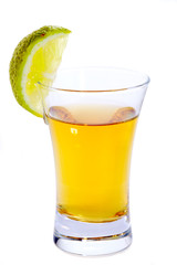 Glass of Tequila shot with lime isolated on white