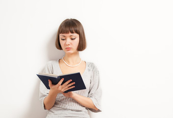 PRetty young woman reading book