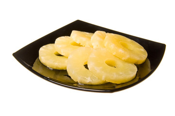 Sliced pineapple on plate isolated on white background