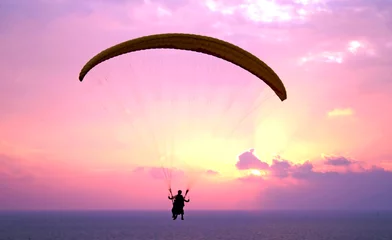 Poster Luchtsport Flight of paraplane above Mediterranean sea on sunset