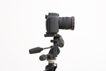 Digital SLR camera on a tripod isolated on white