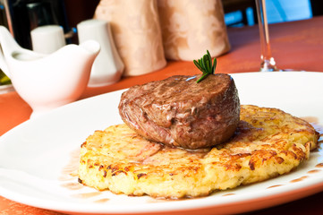 closeup of a Rossini veal with fried potatoes