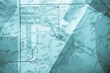 different layers of blue backlit surveyor's plans