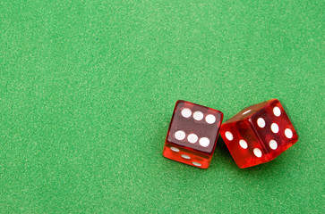 Red dice against green background