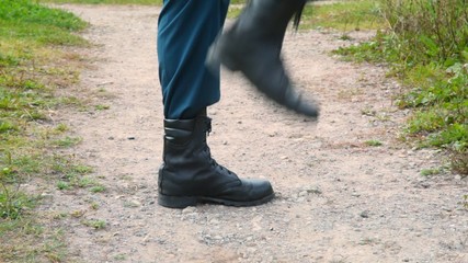 soldier in military boots march on the spot, close up, profile