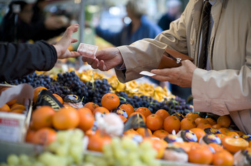 Vendor accepts payment at a street market