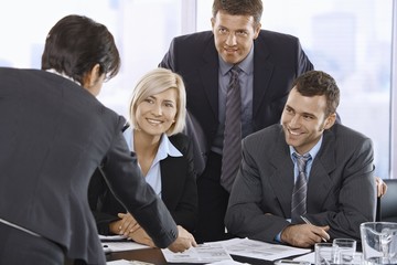 Smiling business team in meeting room