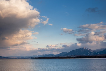 Pink evening clouds over lake