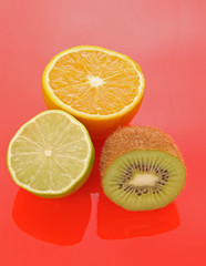 Orange and other fruits on red