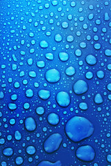 Blue water drops background with big and small drops