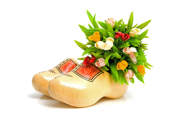 pair of traditional Dutch yellow wooden shoes over white