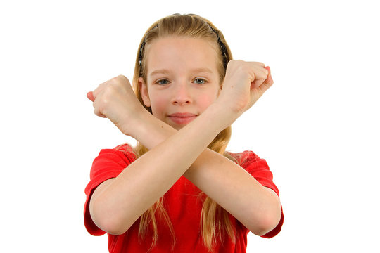 Girl is making X sign over white background
