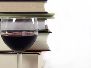 stack of books with a glass of wine