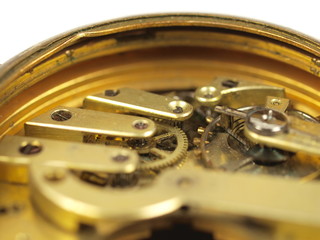 Old clock mechanism on white background