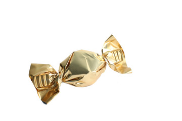 Candy in gold wrapper isolated on white