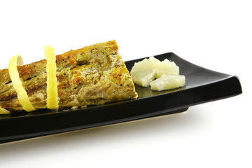 roast tuna with lemon on ceramic plate