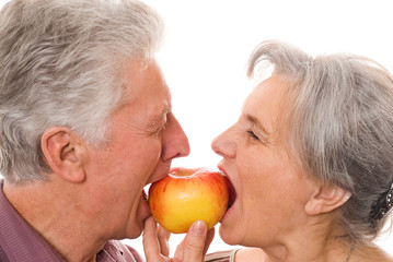 nice elderly couple eating an apple