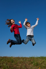Girl and boy jumping, running outdoor