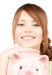 lovely teenage girl with piggy bank