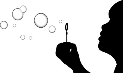 A Silhouette of a young girl blowing bubbles
