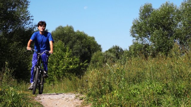 footpath in park on which is passed by turns by two bicycles