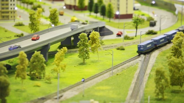 toy passenger express train stops on rail in toy modern sity
