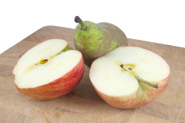 sliced apple and pear on chopping board on white