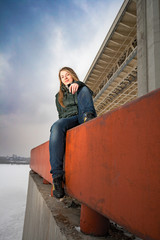 woman sitting on parapet