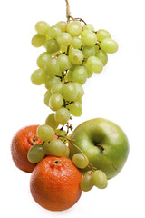 Cluster of grapes in water drops , apple and tangerines