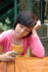 young asian girl holding mobile phone