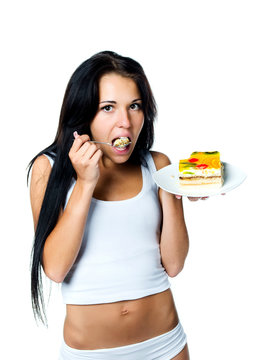 Attractive woman eating a cake