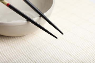 chopsticks at rest on bowl