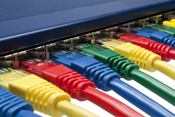 Multi color ethernet plugs connected to a router or switch