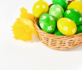 Painted easter eggs in basket on white background with copy spac