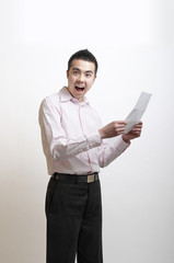 Young Asian man excited by the letter he has just read