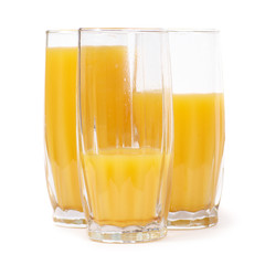 Three glasses with orange juice
