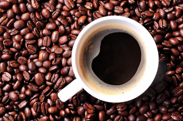Cup of coffee on coffee background