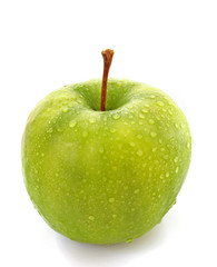 wet green apple covered with  water drops on white background.